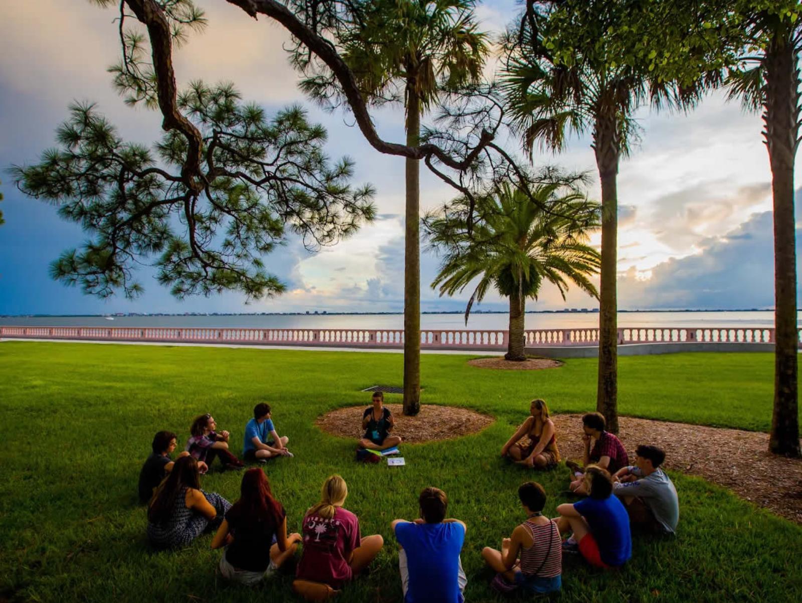 Students and faculty meeting on the bayfront lawn